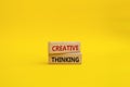 Creative thinkig symbol. Wooden blocks with words Creative thinkig. Beautiful yellow background. Business and Creative thinkig