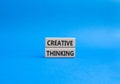 Creative thinkig symbol. Wooden blocks with words Creative thinkig. Beautiful blue background. Business and Creative thinkig