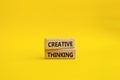Creative thinkig symbol. Wooden blocks with words Creative thinkig. Beautiful yellow background. Business and Creative thinkig