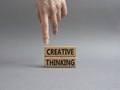 Creative thinkig symbol. Wooden blocks with words Creative thinkig. Businessman hand. Beautiful grey background. Business and Royalty Free Stock Photo