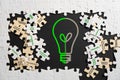Creative Thinking Concept with Light Bulb and Puzzle Pieces Royalty Free Stock Photo