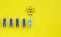 Creative thinking idea and problem solving innovation concept. Miniature figure outstanding from line with light bulb Royalty Free Stock Photo