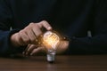 Creative thinking idea for Technology concept.Hand of man touching light bulb with orange glowing and brain icon.Idea concept Royalty Free Stock Photo
