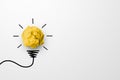 Paper scrap ball yellow colour with light bulb symbol on white background Royalty Free Stock Photo