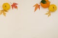 Creative top view flat lay autumn composition. Frame from dried pumpkin leaves on a beige background with copy space. Template Royalty Free Stock Photo