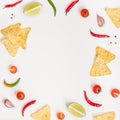 Creative Top view flat lay of fresh mexican food ingredients with tortilla nachos chips garlic pepper lime tomatoes on white table Royalty Free Stock Photo