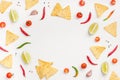 Creative Top view flat lay of fresh mexican food ingredients with tortilla nachos chips garlic pepper lime tomatoes on white table Royalty Free Stock Photo