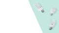 Creative top view flat lay of LED light bulbs mockup composition with copy space on green and white background minimal style. Royalty Free Stock Photo