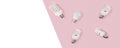 Creative top view flat lay of LED light bulbs mockup composition with copy space on pink and white background minimal style. Royalty Free Stock Photo