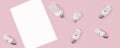Creative top view flat lay of LED light bulbs and white paper mockup composition with copy space on pink background minimal style Royalty Free Stock Photo