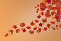 Creative and trendy autumn colorful background made of swirling leaves and sliced dried pumpkin Royalty Free Stock Photo