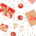 Creative Valentine`s Day greeting card with red decorations and gift boxes, golden heart confetti on white background, copy space Royalty Free Stock Photo