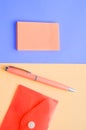 Creative vertical flat lay, top view, office space stationery on coral and purple background