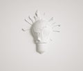 Creative wall art featuring a white light bulb with paint splashes Royalty Free Stock Photo