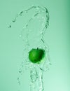 Creative water splashing around apple