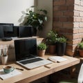 Creative workspace of a blogger. Laptop computer on wooden table in loft style corner office with brick walls and big windows. Des