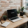 Creative workspace of a blogger. Laptop computer on wooden table in loft style corner office with brick walls and big windows. Des