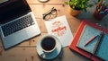 A creative workspace flat lay with coffee, laptop, and inspiring quotes on a clean desk Royalty Free Stock Photo