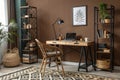 Creative workspace with wooden desk and black rack Royalty Free Stock Photo