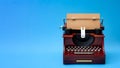 Creative writing, vintage technology and artistic pursuit concept with an retro typewriter isolated on minimalist bright blue