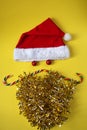 Creative Yellow Christmas background with Santa face and mustache of candy, flay lay