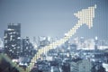 Creative yellow pixel upward arrow on blurry city backdrop. Growth, success business and up concept. Toned image. Double exposure