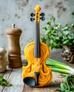 Creative yellow violin with a unique swirling design placed on a rustic wooden table surrounded by herbs and kitchen decor Royalty Free Stock Photo