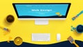 Creative yellow web design studio desk with color brushes and boxes and painted web theme layout on a computer display