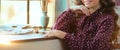 A creative young artist in a lilac dress sits at the window thoughtfully. Close-up. Creative positive girl in art studio Royalty Free Stock Photo