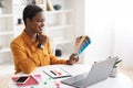 Creative young black woman designer working on laptop Royalty Free Stock Photo