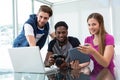 Creative young business team looking at digital tablet Royalty Free Stock Photo