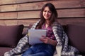 Creative young girl drawing in a jotter while sitting on sofa at Royalty Free Stock Photo