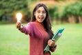Creative young woman hold shinning light bulb. Royalty Free Stock Photo