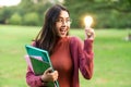 Creative young woman hold shinning light bulb. Royalty Free Stock Photo