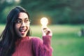 Creative young woman hold shinning light bulb. Royalty Free Stock Photo