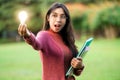 Creative young woman hold shinning light bulb. Royalty Free Stock Photo