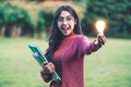 Creative young woman hold shinning light bulb. Royalty Free Stock Photo