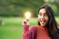 Creative young woman hold shinning light bulb. Royalty Free Stock Photo