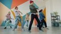 Creative youth dancing together during practive in modern studio