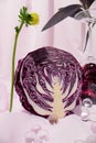 Creatively arranged purple cabbage against light violet background