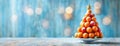 Christmas tree made of stacked tangerines, topped with a golden star. The festive fruit arrangement sits against a Royalty Free Stock Photo