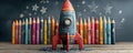 Colorful rocket sculpture with stars and crayons in whimsical chalkboard setting Royalty Free Stock Photo