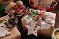 Creatively wrapped Christmas gift in rustic style on wooden table