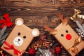 Creatively wrapped Christmas gifts in the shape of a teddy bear and a deer. New Year and Christmas concept. DIY gift wrapping.