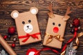 Creatively wrapped Christmas gifts in the shape of a teddy bear and a deer. New Year and Christmas concept. DIY gift wrapping.