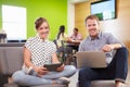 Creatives Having Informal Meeting On Sofas In Design Studio Royalty Free Stock Photo