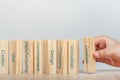 Creativity concept. Hand places the wooden rectangles next to the others, creating a wall of wooden cubes with the words