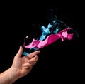 Creativity concept hand throwing paint on black background Royalty Free Stock Photo