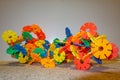 Creativity game for kids . Colored flower plastic plates which can be stacked . Building construction art . Stacking flower toy in Royalty Free Stock Photo