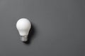 Creativity inspiration, great business idea concept with white light bulb on black background. Royalty Free Stock Photo